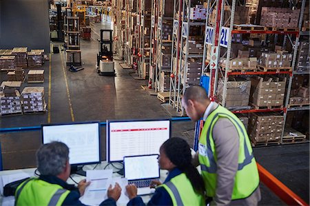 forklift - Managers working meeting at laptop and computers in distribution warehouse Stock Photo - Premium Royalty-Free, Code: 6124-08820903