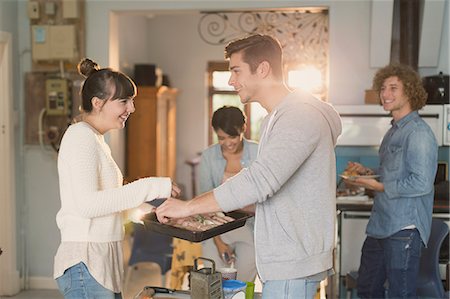 simsearch:6113-06908601,k - Young couples roommates cooking in kitchen Stock Photo - Premium Royalty-Free, Code: 6124-08821085