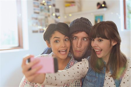 simsearch:6113-06908601,k - Playful young friends taking selfie making silly faces Stock Photo - Premium Royalty-Free, Code: 6124-08821004