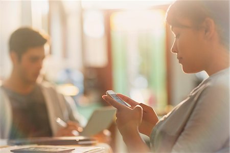 seeing - Young woman texting with cell phone Stock Photo - Premium Royalty-Free, Code: 6124-08821008