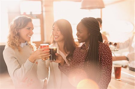 simsearch:6113-07147381,k - Women friends toasting beer glasses at bar Stock Photo - Premium Royalty-Free, Code: 6124-08946001