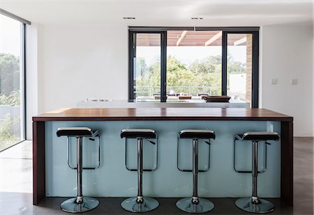 Simple, modern home showcase interior kitchen island with barstools Stock Photo - Premium Royalty-Free, Code: 6124-08907894