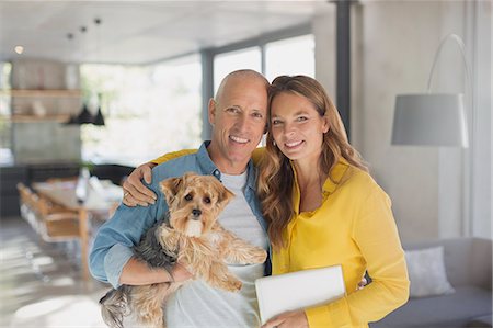 simsearch:6113-06720867,k - Portrait smiling mature couple hugging with dog in living room Stock Photo - Premium Royalty-Free, Code: 6124-08908130
