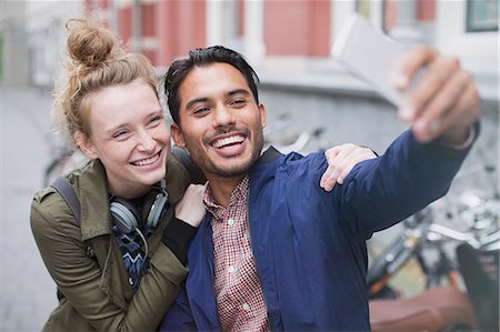 simsearch:632-07674444,k - Smiling young couple taking selfie with camera phone Stock Photo - Premium Royalty-Free, Code: 6124-08926857