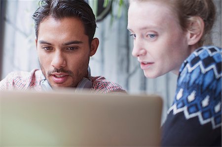 serious woman - Serious young man and woman using laptop in cafe Stock Photo - Premium Royalty-Free, Code: 6124-08926865