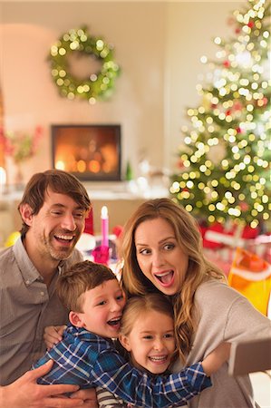 simsearch:649-08232457,k - Silly family taking selfie with camera phone in Christmas living room Stock Photo - Premium Royalty-Free, Code: 6124-08926922