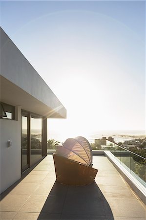 simsearch:6124-08703974,k - Covered patio chair on sunny modern luxury balcony under blue sky Stock Photo - Premium Royalty-Free, Code: 6124-08927043