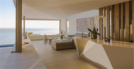 simsearch:6124-08703974,k - Modern, luxury home showcase living room open to ocean view Stock Photo - Premium Royalty-Free, Code: 6124-09099789