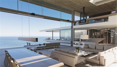simsearch:6124-08703974,k - Modern, luxury home showcase interior living room and dining room with ocean view Stock Photo - Premium Royalty-Free, Code: 6124-09099731