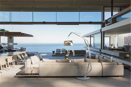 simsearch:6124-08703974,k - Modern, luxury home showcase interior living room open to ocean view Stock Photo - Premium Royalty-Free, Code: 6124-09099803