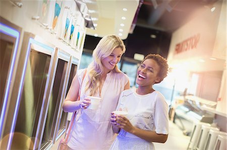 simsearch:6113-07147381,k - Laughing young lesbian couple enjoying frozen yogurt Stock Photo - Premium Royalty-Free, Code: 6124-09004860