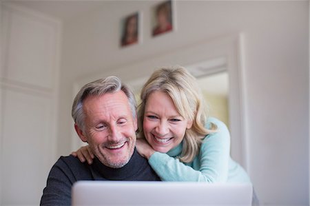 skype - Smiling, happy mature couple using laptop Stock Photo - Premium Royalty-Free, Code: 6124-09143752
