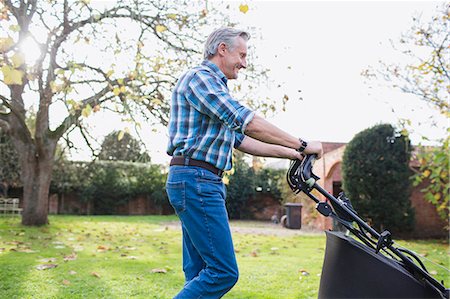 retirement and active - Senior man moving lawn with lawnmower in autumn backyard Stock Photo - Premium Royalty-Free, Code: 6124-09167246