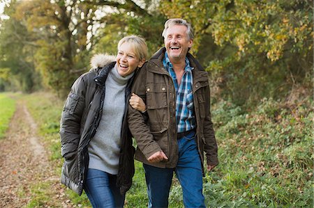 simsearch:400-04035087,k - Happy, carefree mature couple walking arm in arm in autumn park Stock Photo - Premium Royalty-Free, Code: 6124-09167264