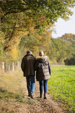 simsearch:400-04035087,k - Affectionate mature couple walking in sunny, rural autumn field Stock Photo - Premium Royalty-Free, Code: 6124-09167288