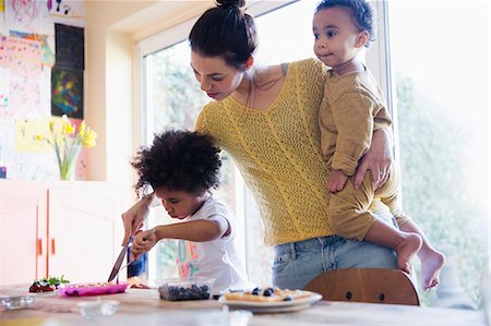 simsearch:6108-06907066,k - Mother helping toddler daughter cutting breakfast waffles Stock Photo - Premium Royalty-Free, Code: 6124-09167372