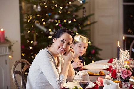 simsearch:6113-07147647,k - Portrait smiling mother and daughter enjoying candlelight Christmas dinner Stock Photo - Premium Royalty-Free, Code: 6124-09177922