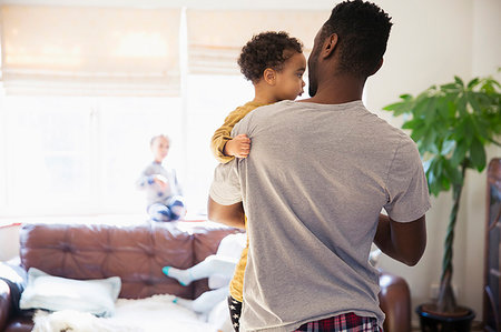 simsearch:6116-07236010,k - Father holding baby son in living room Stock Photo - Premium Royalty-Free, Code: 6124-09178053