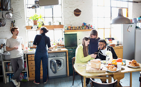 simsearch:6113-08743448,k - Young adult roommate friends enjoying breakfast in apartment kitchen Stock Photo - Premium Royalty-Free, Code: 6124-09188497