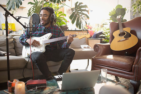 simsearch:614-06719795,k - Young male musician recording music, playing guitar and singing into microphone in apartment Stock Photo - Premium Royalty-Free, Code: 6124-09188494