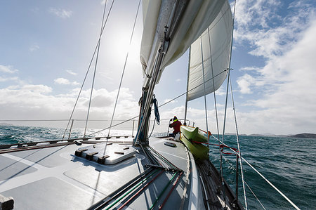 sailing - Woman at bow of sailboat on sunny ocean, Vava'u, Tonga, Pacific Ocean Stock Photo - Premium Royalty-Free, Code: 6124-09188654