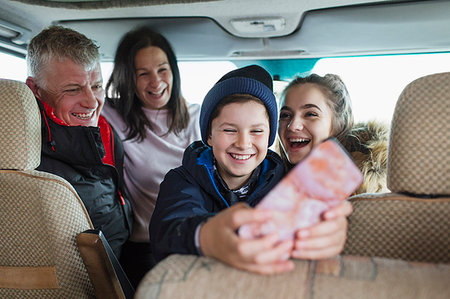 phone happy sitting - Happy family with smart phone in motor home Stock Photo - Premium Royalty-Free, Code: 6124-09188874