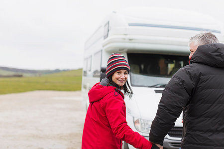 simsearch:6113-07242393,k - Portrait smiling couple in warm clothing holding hands outside motor home Stock Photo - Premium Royalty-Free, Code: 6124-09188882