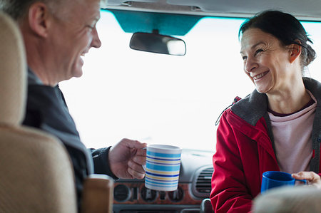 Happy couple drinking coffee in motor home Stock Photo - Premium Royalty-Free, Code: 6124-09188831