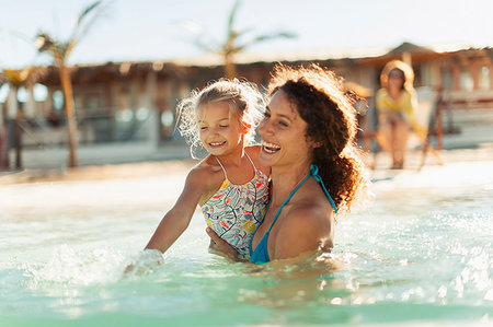 simsearch:6113-06909372,k - Happy mother and daughter swimming in sunny ocean Stock Photo - Premium Royalty-Free, Code: 6124-09269490