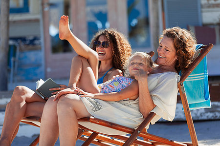 simsearch:6113-08393683,k - Playful, happy multi-generation women relaxing on sunny beach Stock Photo - Premium Royalty-Free, Code: 6124-09269574