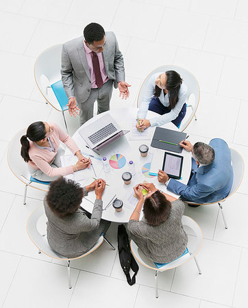 simsearch:6113-06899132,k - High angle view businessman leading meeting at round table Stock Photo - Premium Royalty-Free, Code: 6124-09229209