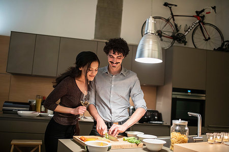 simsearch:6109-08390293,k - Couple cutting vegetables, cooking dinner in apartment kitchen Stock Photo - Premium Royalty-Free, Code: 6124-09239471