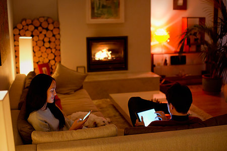 simsearch:614-02985269,k - Couple using digital tablet and smart phone in living room Stock Photo - Premium Royalty-Free, Code: 6124-09239562