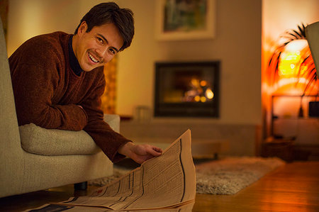 simsearch:614-02985269,k - Portrait smiling man reading newspaper in living room Stock Photo - Premium Royalty-Free, Code: 6124-09239574