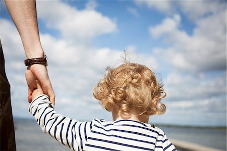 simsearch:6126-08644727,k - Sweden, Skane, Man holding his daughter's (2-3) hand Stock Photo - Premium Royalty-Free, Code: 6126-08642930