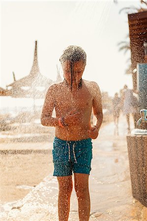 shower kid - Turkey, Alanya, Girl (8-9) standing under shower on beach Photographie de stock - Premium Libres de Droits, Code: 6126-08643275