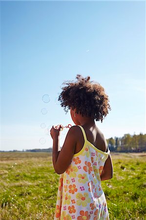 Sweden, Vastra Gotaland, Gullspang, Runnas, Girl (6-7) blowing soap bubbles Stock Photo - Premium Royalty-Free, Code: 6126-08643757