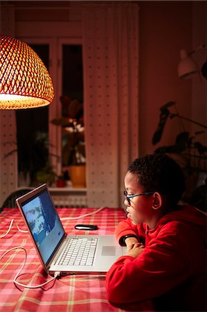 sweden window lamp - Sweden, Vastra Gotaland, Vastra frolunda, Uppegardsvagen, Boy (10-11) using laptop Stock Photo - Premium Royalty-Free, Code: 6126-08643737