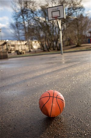 Sweden, Vastergotland, Lerum, Basketball on asphalt Stock Photo - Premium Royalty-Free, Code: 6126-08643859