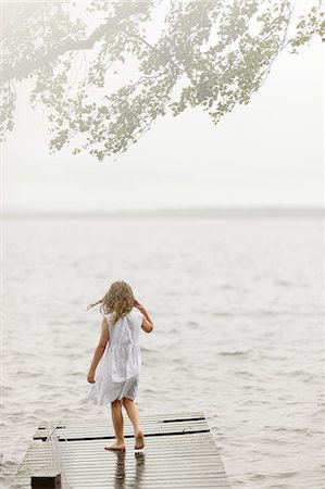 simsearch:6126-08644727,k - Sweden, Vastmanland, Bergslagen, Hallefors, Sangshyttan, Girl (4-5) standing on jetty by lake Stock Photo - Premium Royalty-Free, Code: 6126-08643972