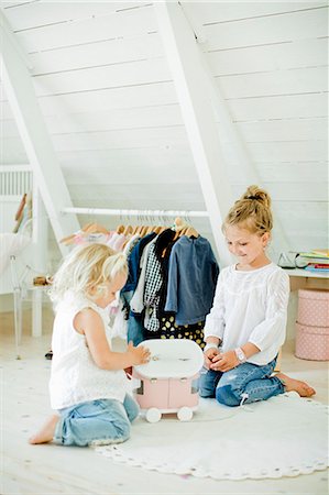 simsearch:6126-08644727,k - Sweden, Sisters (2-3, 6-7) playing with toy truck in bedroom Stock Photo - Premium Royalty-Free, Code: 6126-08643917