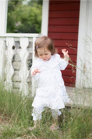 simsearch:6126-08644727,k - Sweden, Vasterbotten, Hemavan, Girl (2-3) exploring backyard Stock Photo - Premium Royalty-Free, Code: 6126-08643930