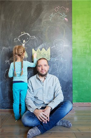 finnish ethnicity - Finland, Girl (4-5) standing by father and drawing on chalkboard Stock Photo - Premium Royalty-Free, Code: 6126-08644740