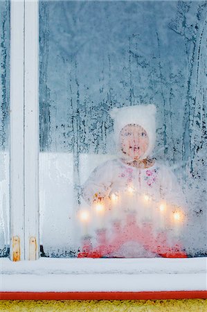 Finland, Heinola, Girl (2-3) looking out frosted window Stock Photo - Premium Royalty-Free, Code: 6126-08644713