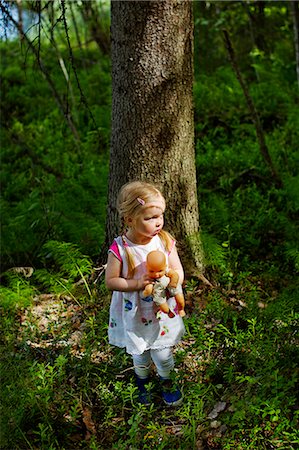 simsearch:6126-08644727,k - Finland, Paijat-Hame, Girl (2-3) with doll standing in front of tree Stock Photo - Premium Royalty-Free, Code: 6126-08644717