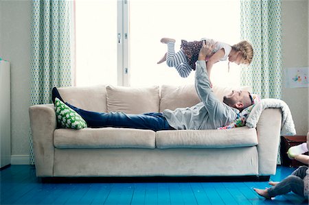 simsearch:6126-08644727,k - Finland, Father playing with daughters (12-17 months, 2-3) in living room Stock Photo - Premium Royalty-Free, Code: 6126-08644736