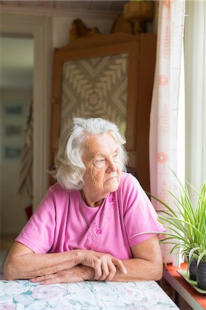 drawing room - Sweden, Ostergotland, Finspang, Senior woman looking through window Stock Photo - Premium Royalty-Free, Code: 6126-08659057