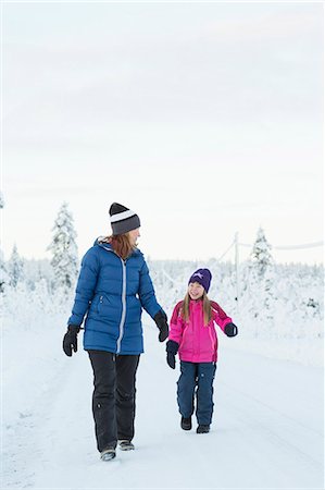 simsearch:6126-08644727,k - Sweden, Lapland, Gallivare, Girl (4-5) walking with mother along road in winter Stock Photo - Premium Royalty-Free, Code: 6126-08659263