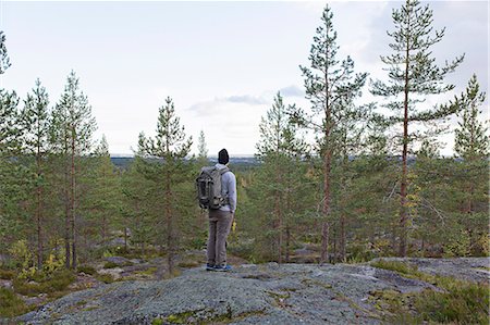 simsearch:6126-08643505,k - Sweden, Vasterbotten, Umea, Man standing on rocks looking at view Stock Photo - Premium Royalty-Free, Code: 6126-08659285