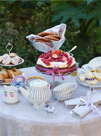 forked - Sweden, Table in garden with teapot and cakes Stock Photo - Premium Royalty-Free, Code: 6126-08659382